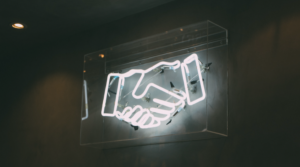 A Neon Sign of a Handshake