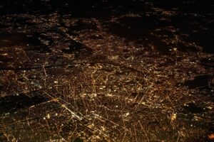 Bird view of a city at night with lights.